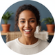 Close-up portrait of a smiling young woman, conveying satisfaction and trust.
